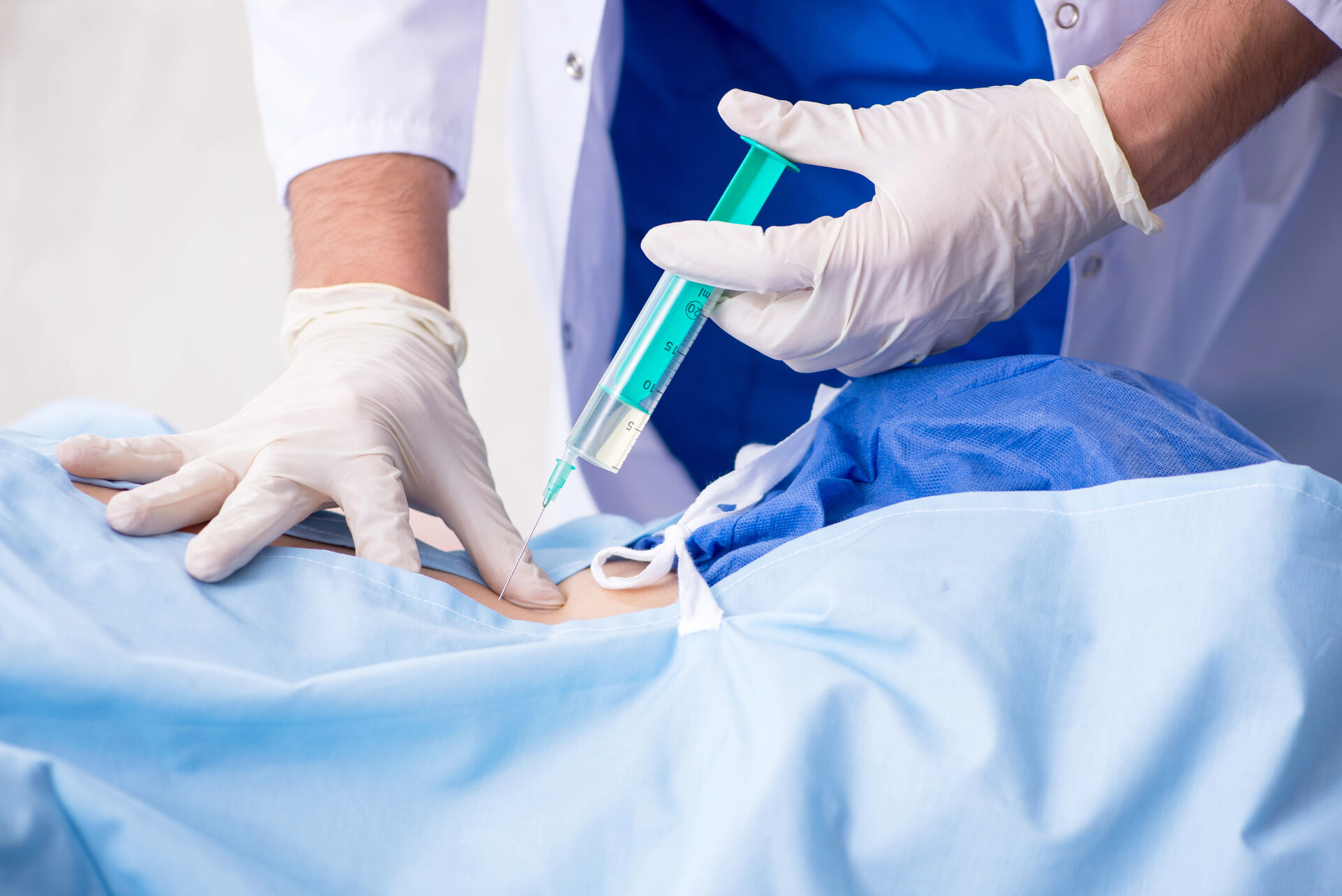 Physician performing a facet joint injection under guidance