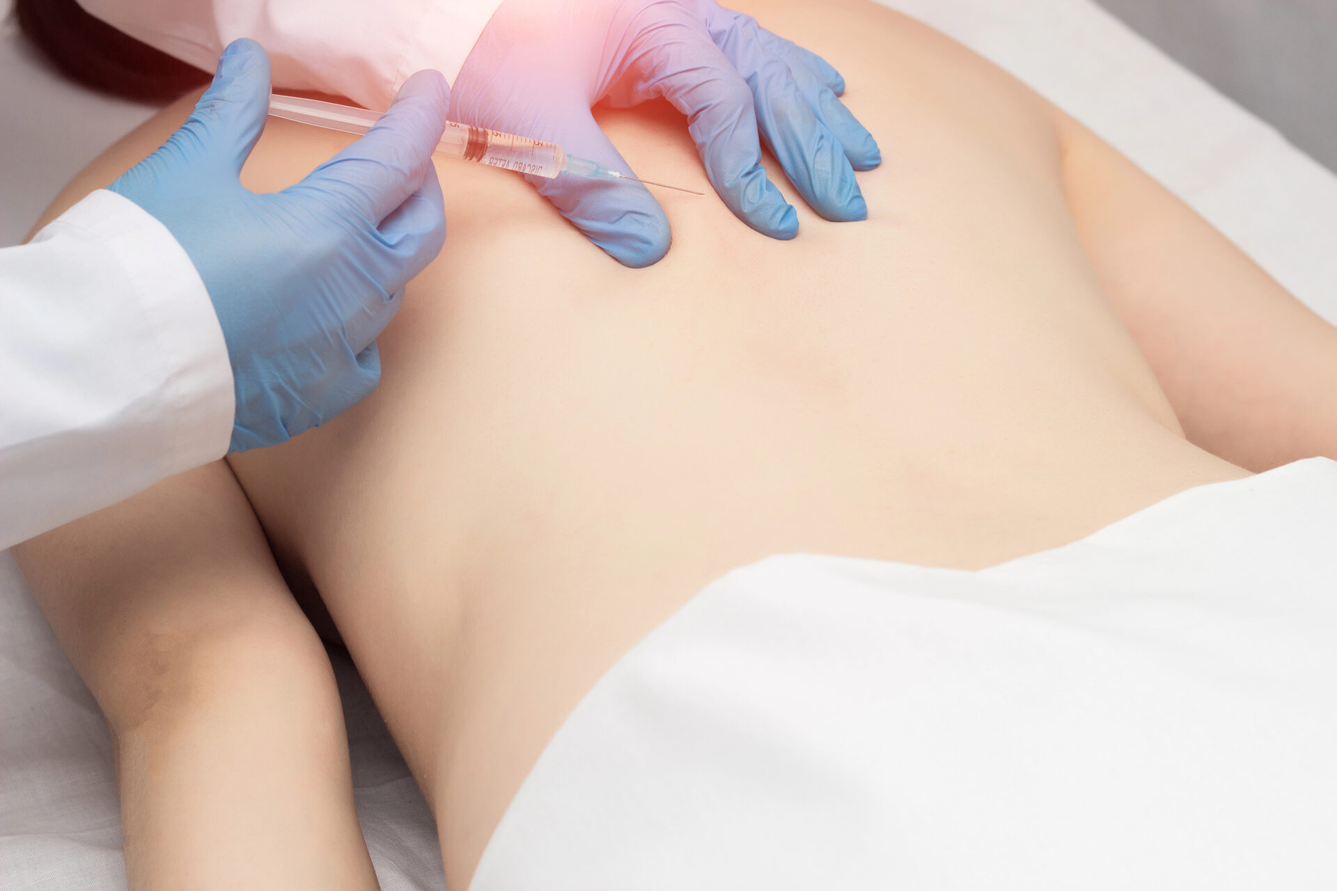 Doctor injecting trigger points to relieve muscle spasm